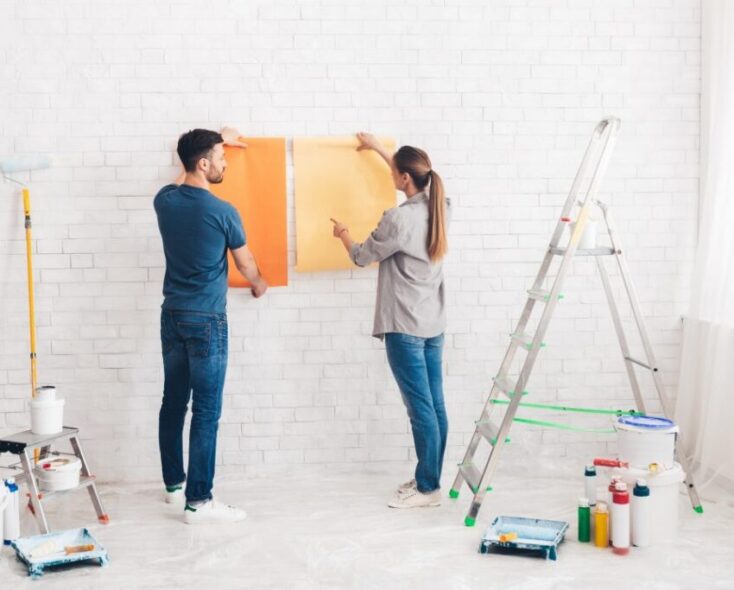 young-happy-couple-choosing-in-what-color-painting-their-new-house